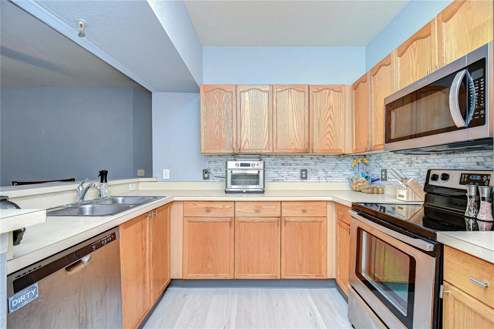 Kitchen area with Whirlpool appliances that come with this condo.
