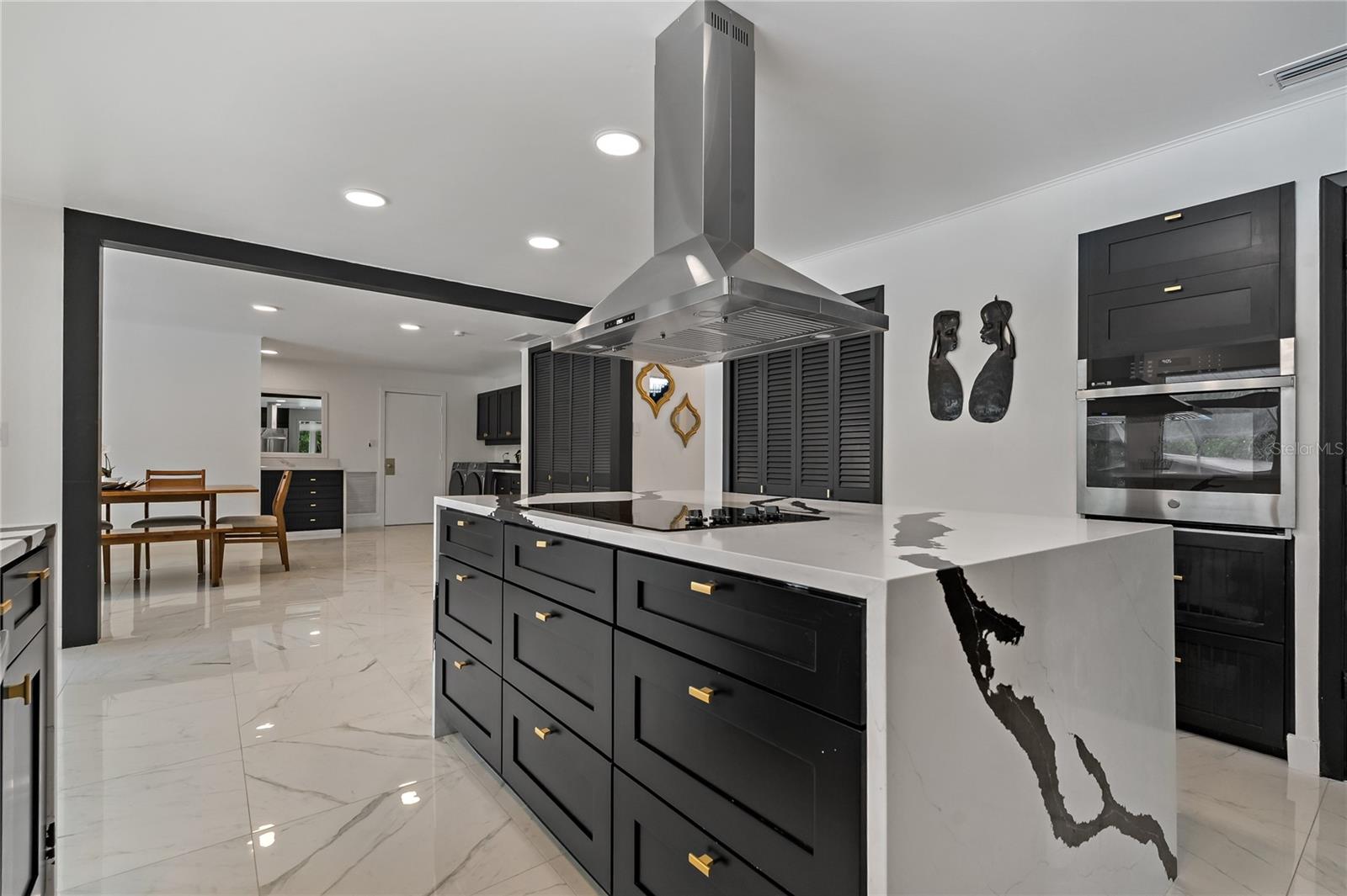 Stainless Steel Range Hood situated perfectly over the Quartz Waterfall Island