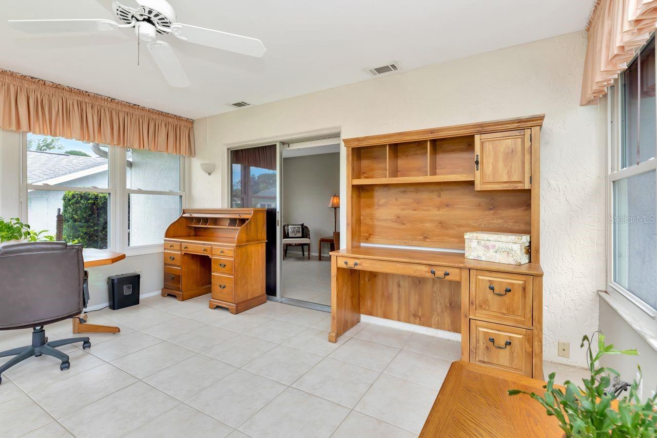 As you can ascertain from the computer desk, the Florida room was so enjoyed by the sellers that they even set up their offices in it as this room was their favorite.