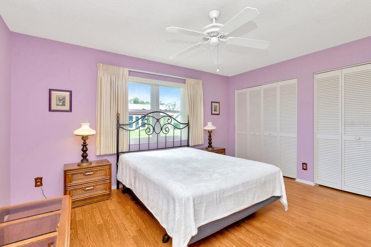 The hardwood floors give  the primary bedroom a stylist look.