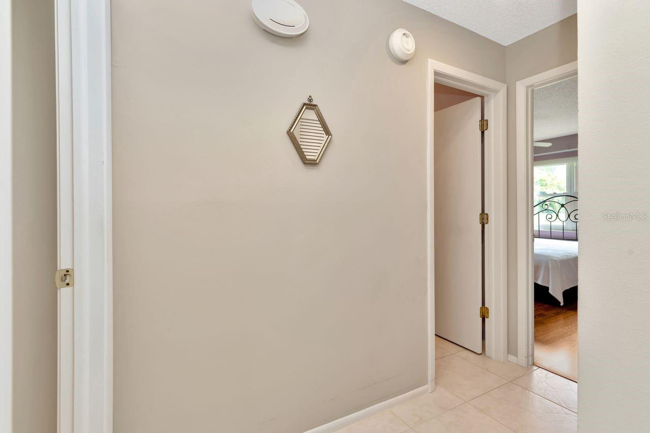 Hallway going from the primary bedroom to the second bedroom.