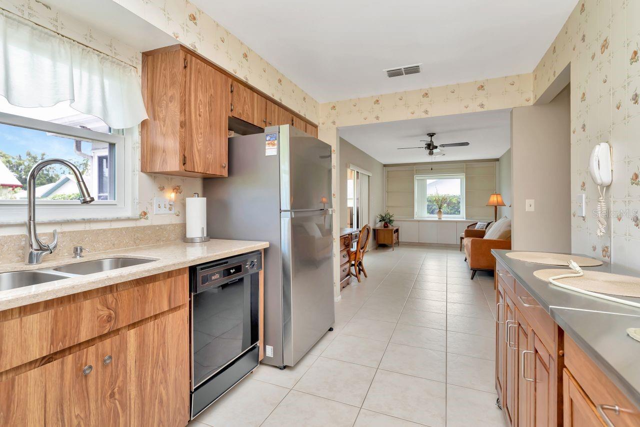 Kitchen flows into the den/family room/dining room.