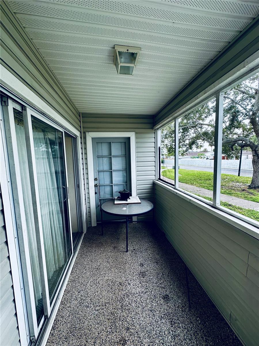 Screened-In Patio with Sliding Door to Living Room and Door to Bedroom 3/Den/Office