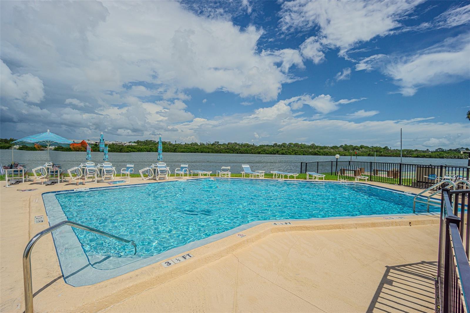 Community pool overlooks waterway for a relaxing afternoon!