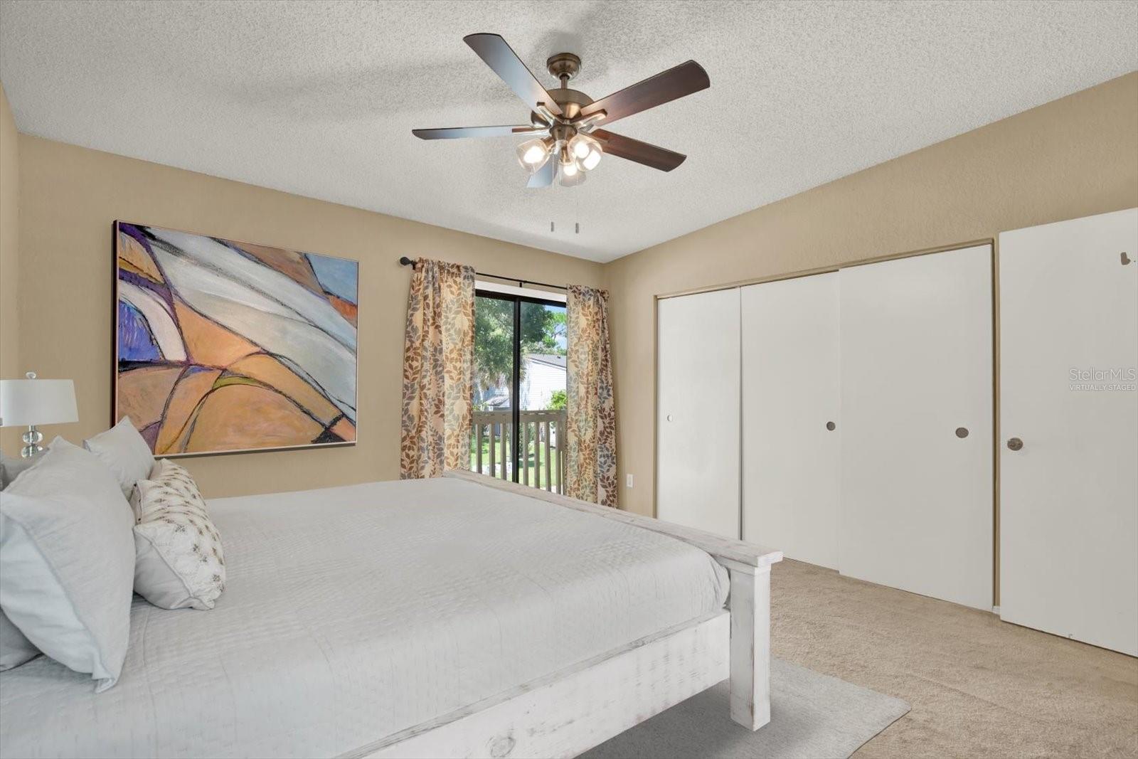 *Virtually staged* Primary Bedroom with private balcony and ensuite full tub/shower and granite counters.