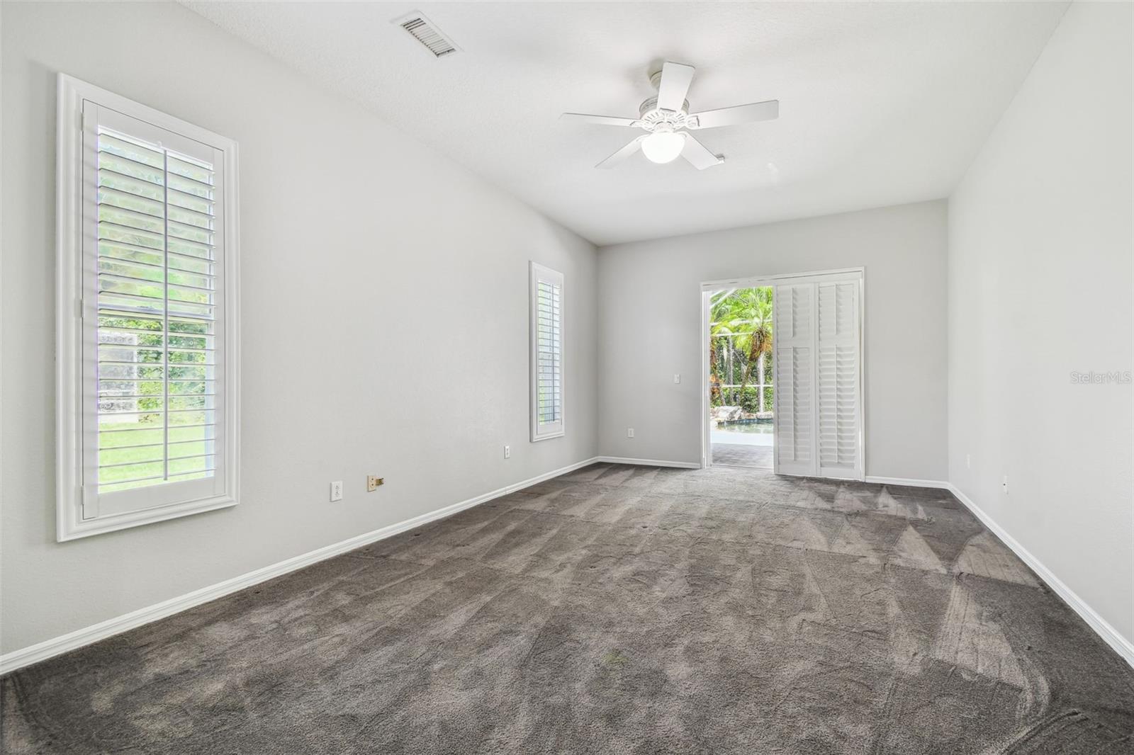 Primary Bedroom w/Plantation Shutters & Sliding Glass (Pocket) Doors to Lanai