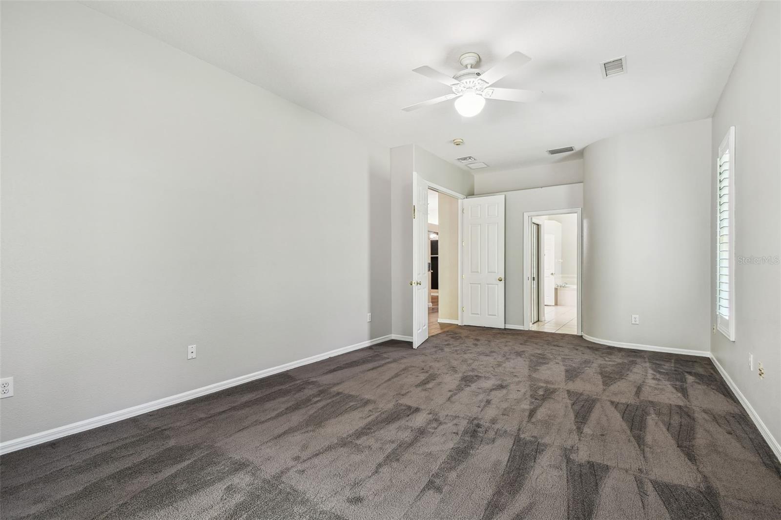 Primary Bedroom w/Plantation Shutters & Double Door Entry