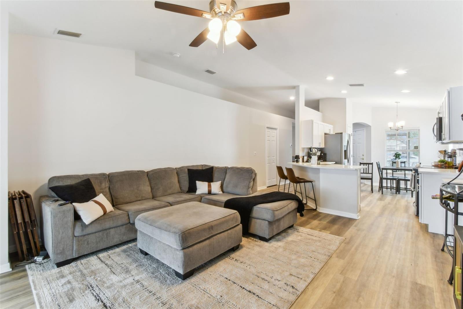 Living area overlooking kitchen and sliding doors to large patio