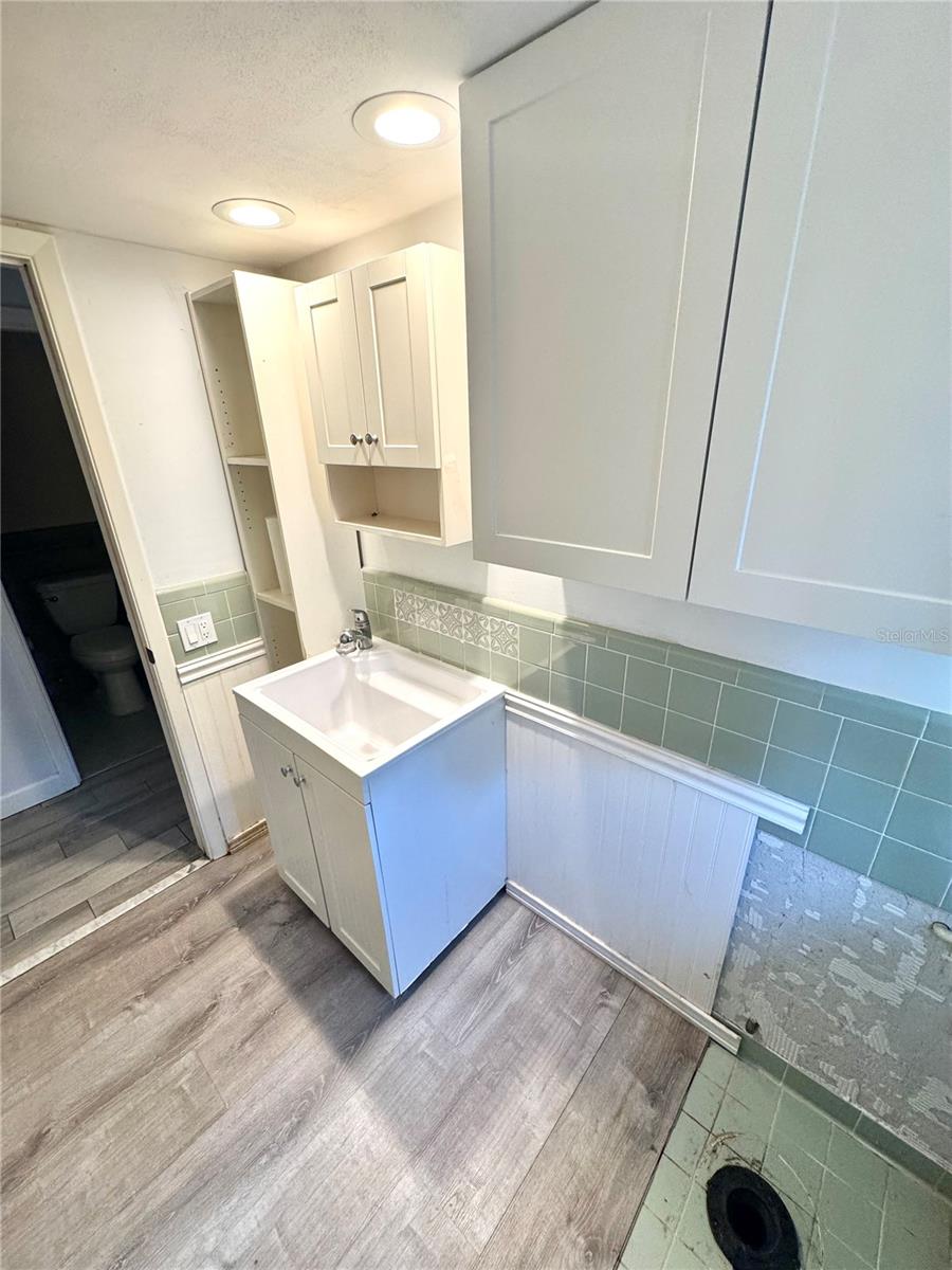 The laundry room is plumbed for a toilet as well as washer and dryer