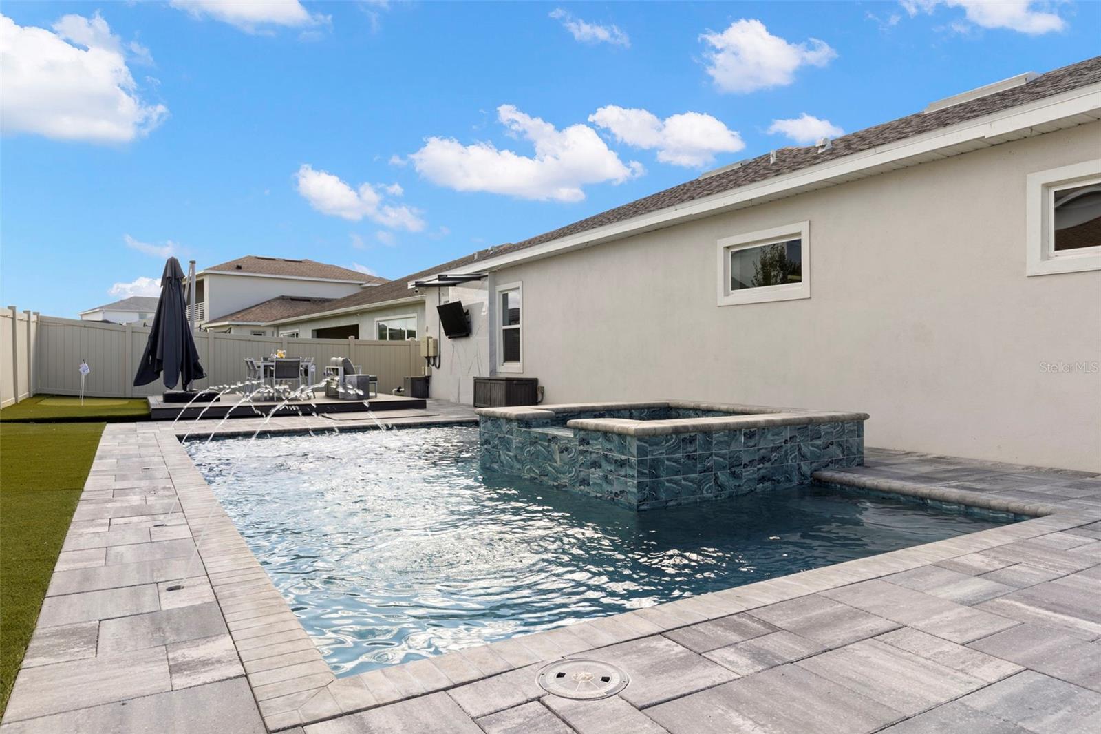 beautifully upgraded backyard oasis featuring a saltwater pool, spa.