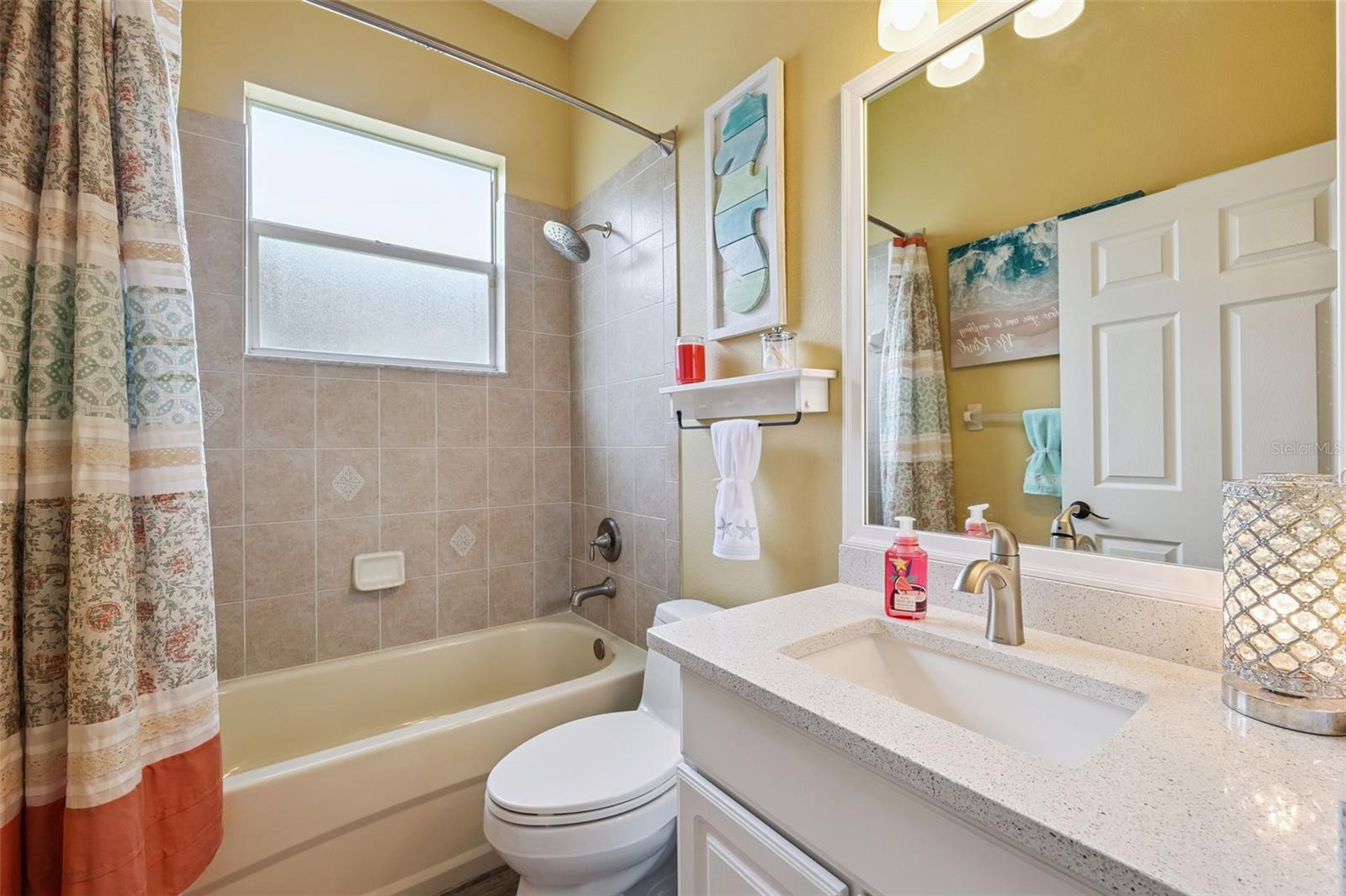 House bathroom with tub and updated vanity.