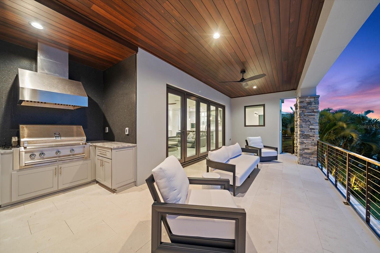 Outdoor kitchen is perfectly situated to enhance weekend gatherings with family and friends.