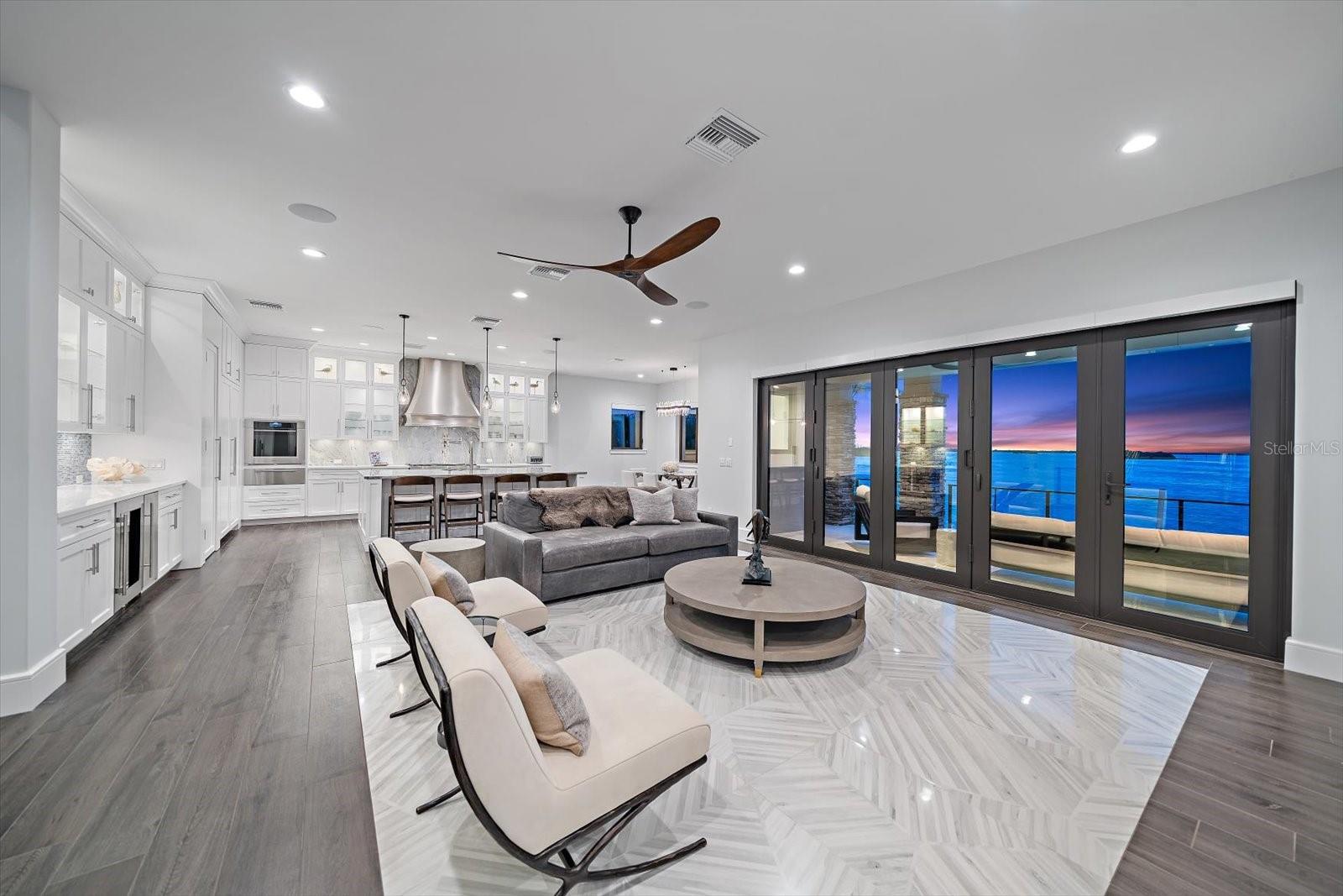 Innovative accordion style folding doors allow the outdoors to connect to the gorgeous interior instantly.