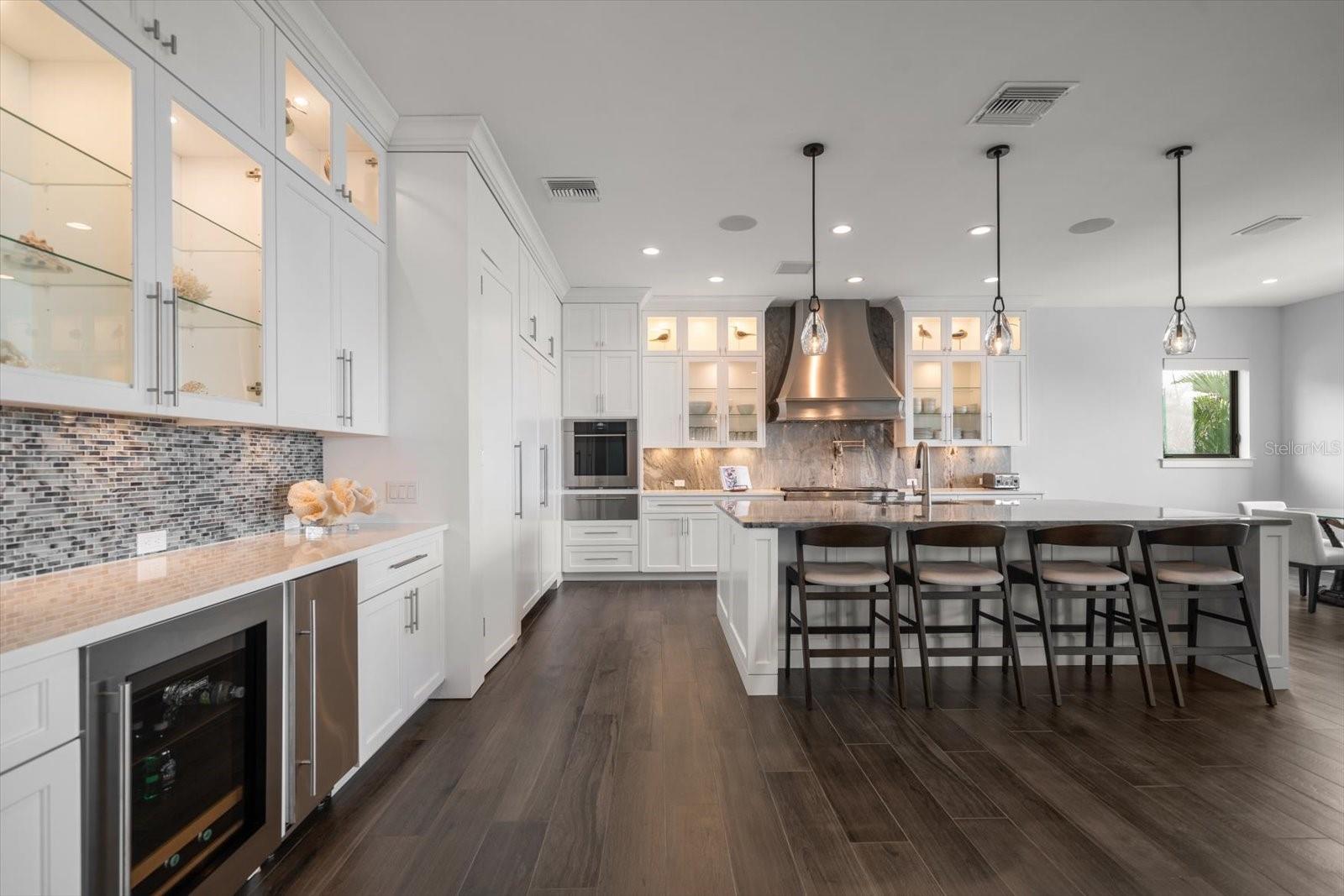 Dream kitchen area with walk in pantry, inviting breakfast bar-perfect for entertaining and top of the line appliances-certain to impress the fussiest chefs!