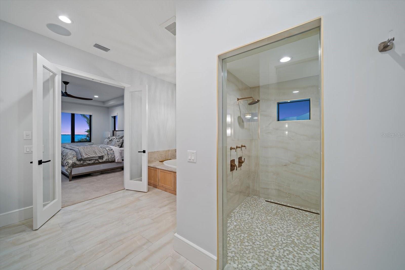 Accessed through a double door entry from the primary bedroom area, the bath area is spacious!