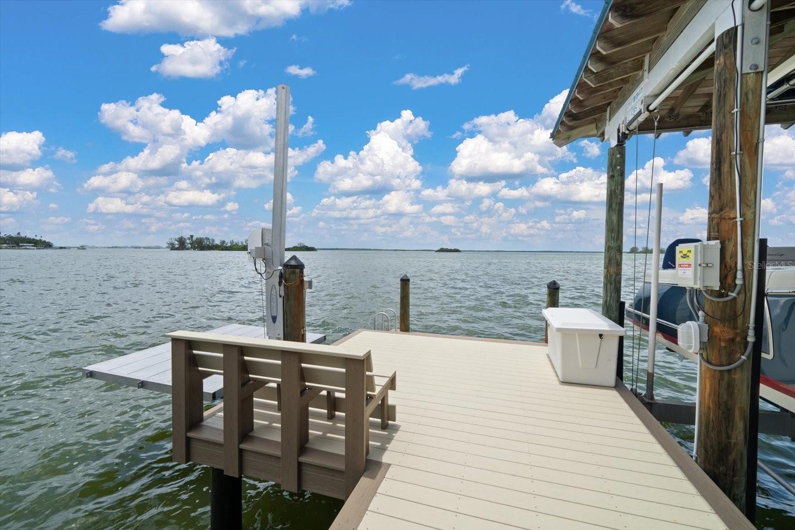 Low profile platform for jet ski or kayak, paddleboard launch. Low maintenance composite decking, covered slip to accommodate vessels up to 16,000 pounds