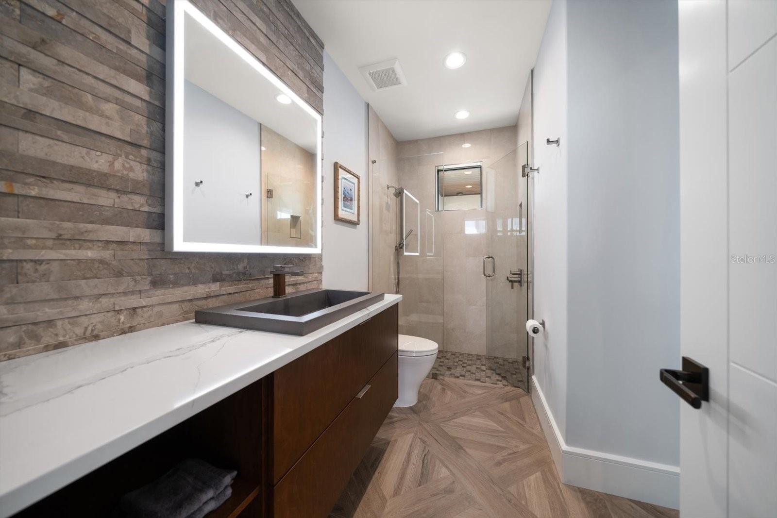 Additional bathroom on second living level adjacent to office and fourth bedroom/media room