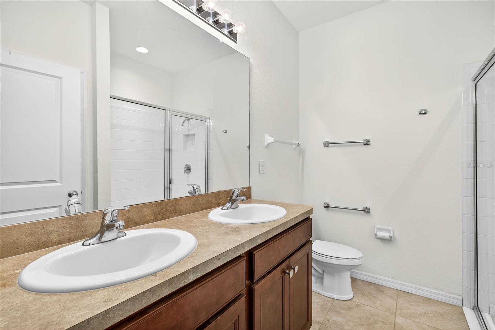 Primary ensuite bath with dual sinks and walk in shower