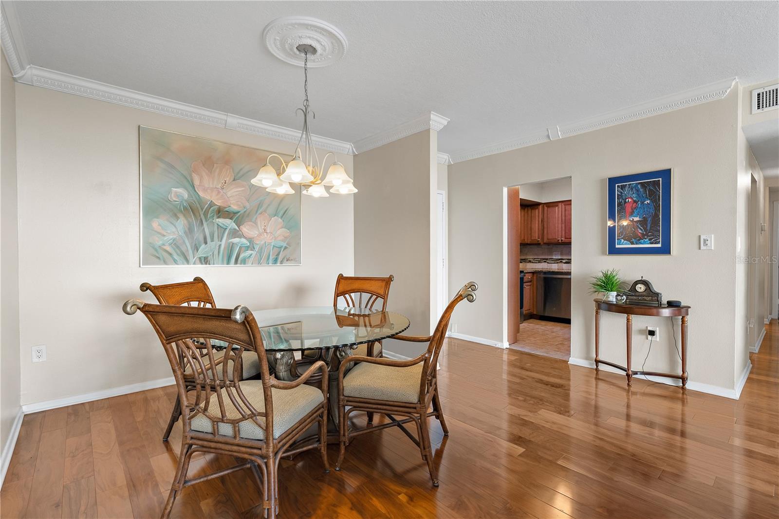 The Dining Room is open to the Living Room and  has matching crown molding and wood flooring.
