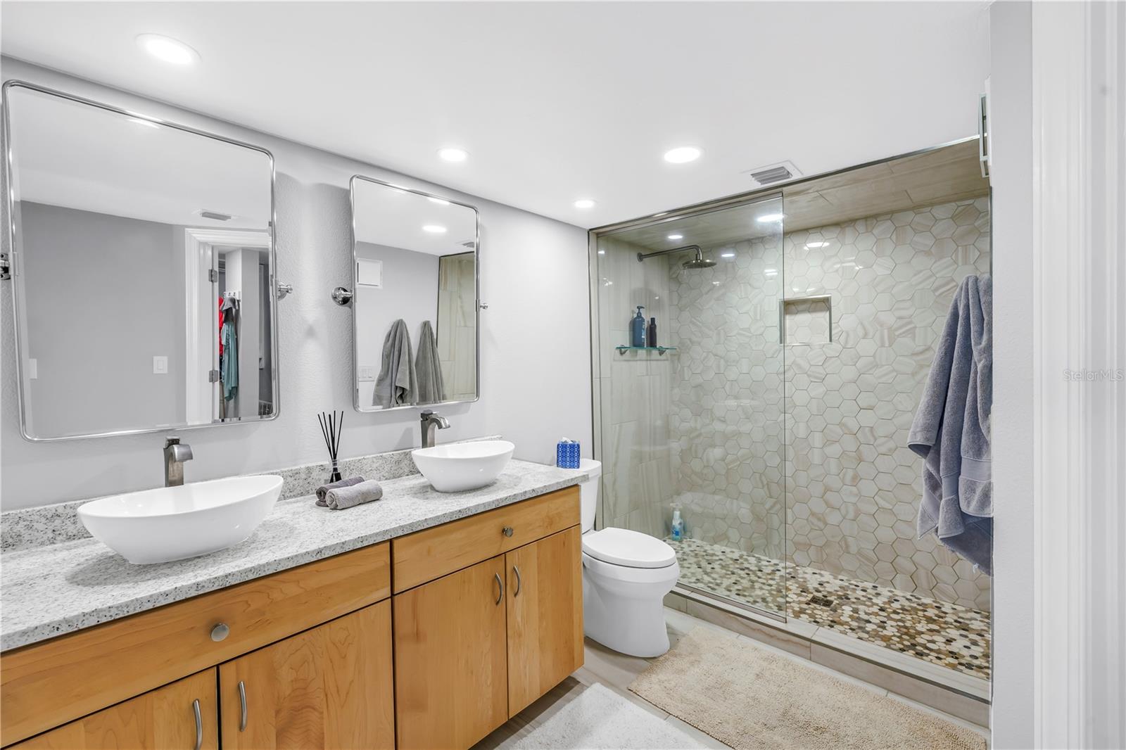 Primary bathroom with double sinks and a walk in shower