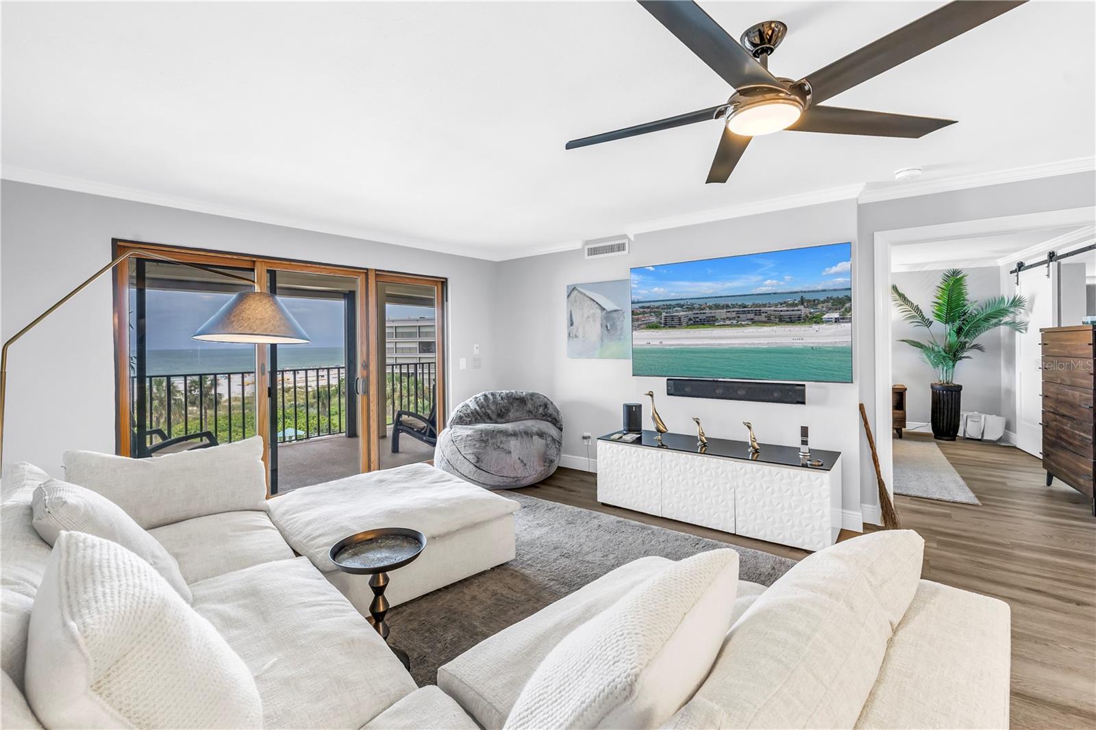 Living area with opening to the master suite and a slider to the balcony.