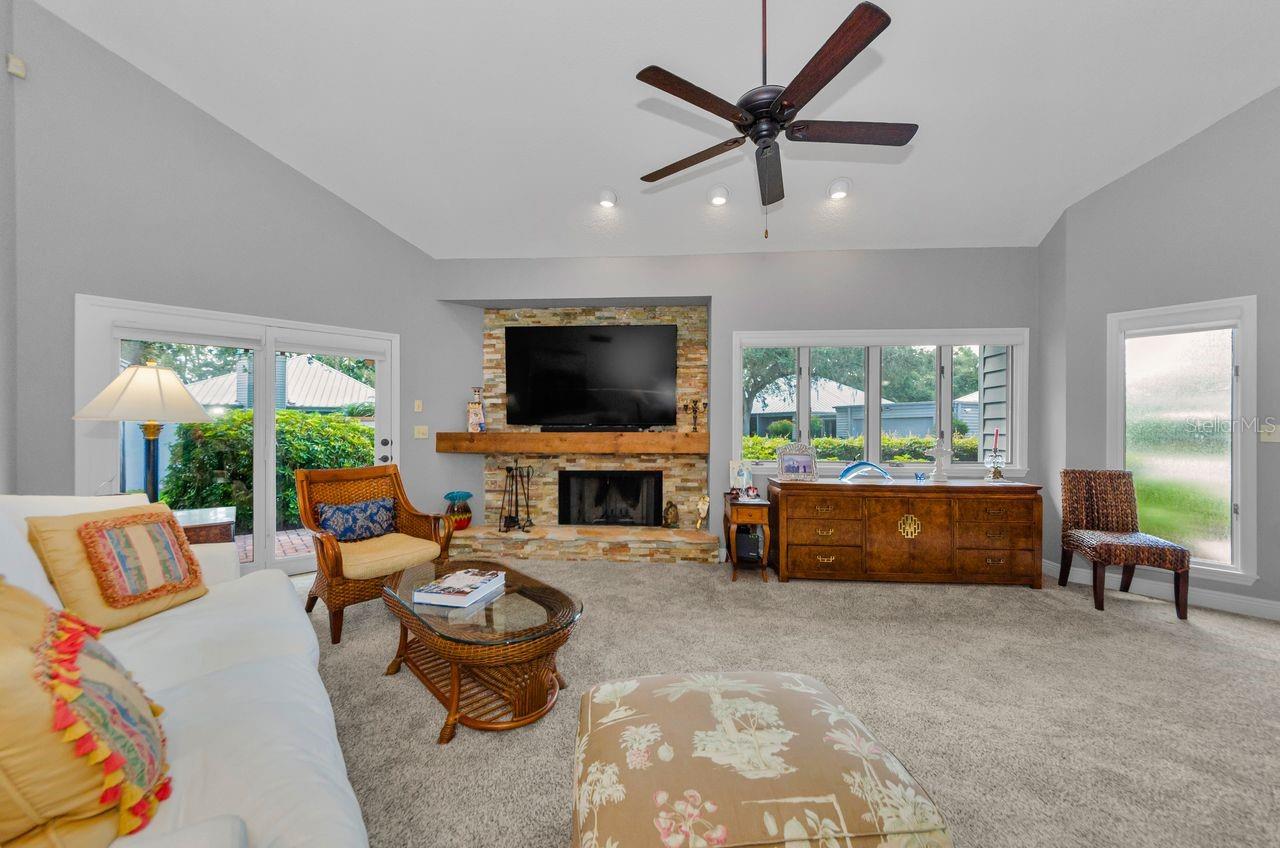 Spacious living room with soaring vaulted ceilings and so much light. Windows have shades that give privacy in the evenings.