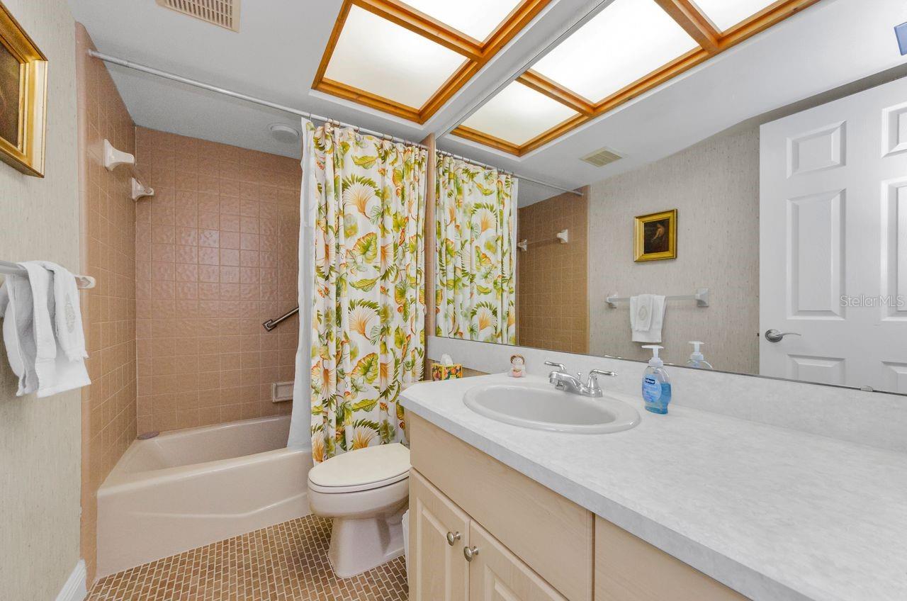 Hall bath with shower/tub combination. Located between the two guest rooms.