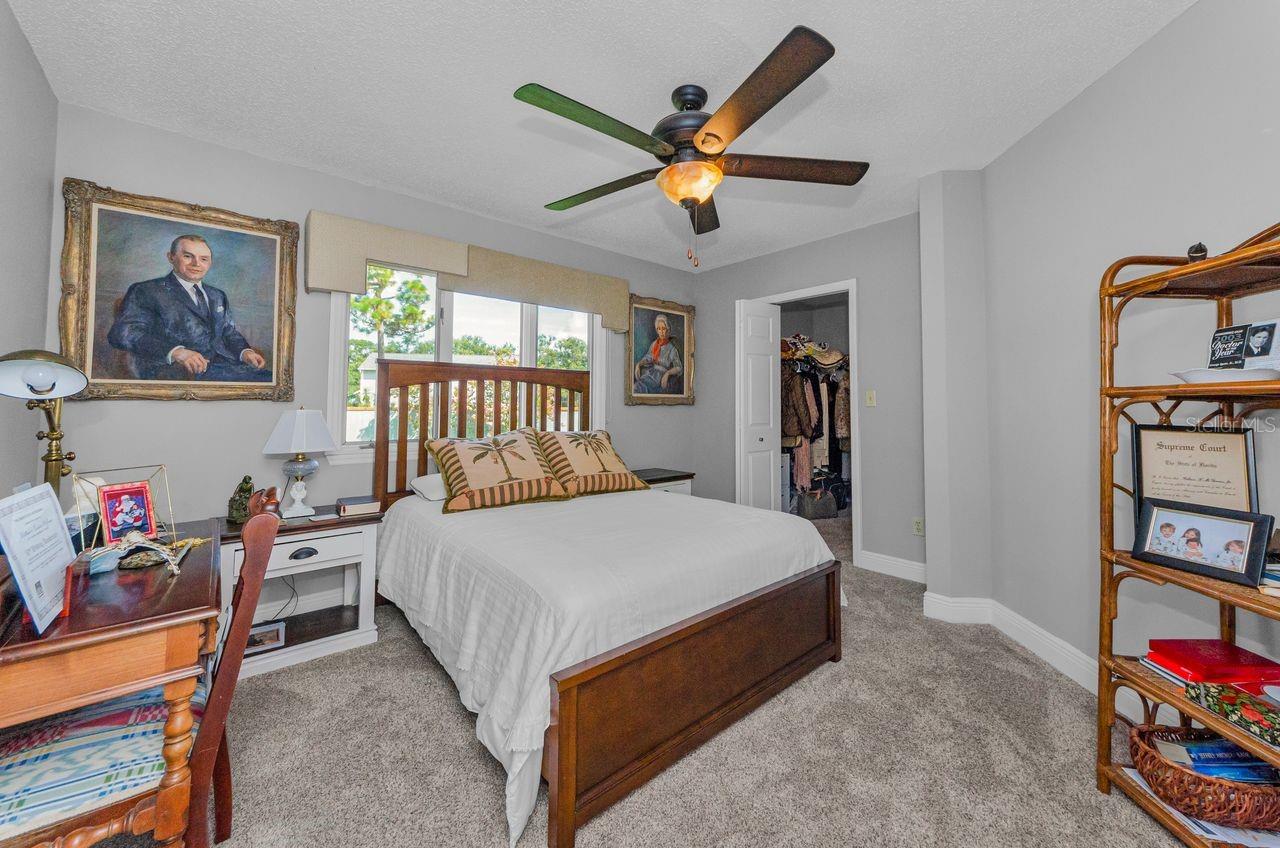 Guest bedroom #2 with walk in closet and view of the large back yard! Adjacent to the hall bath!