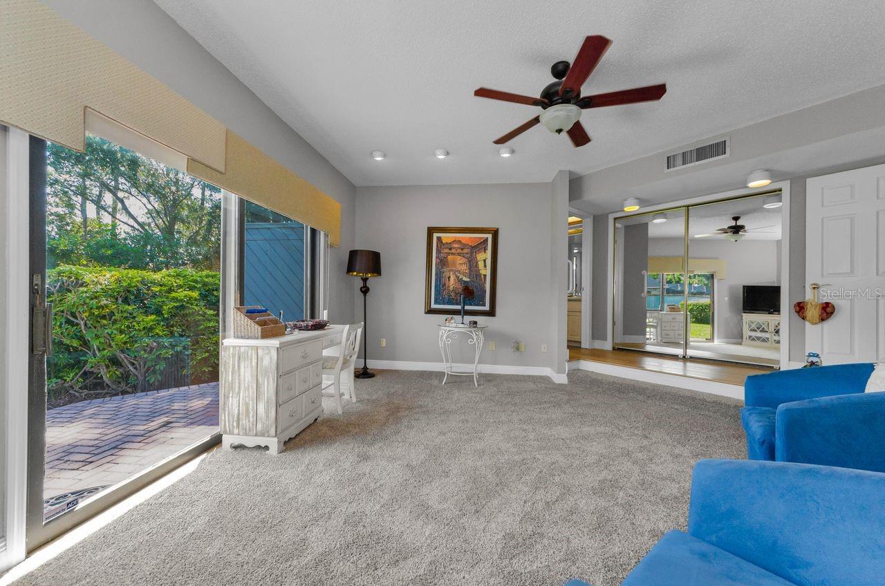 Primary Bedroom, staged as a sitting room has it's own patio and private ensuite bath.