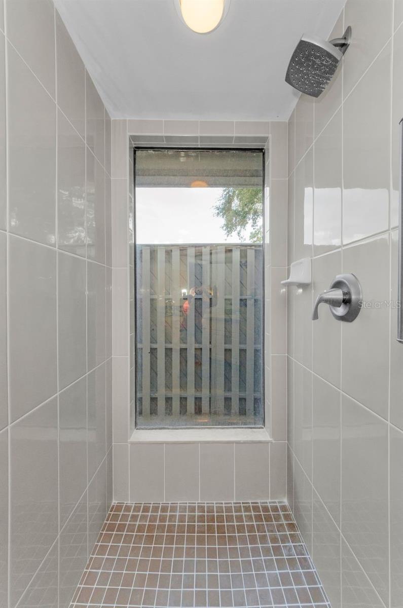 Master shower, garden design, walled area outside the window for privacy.