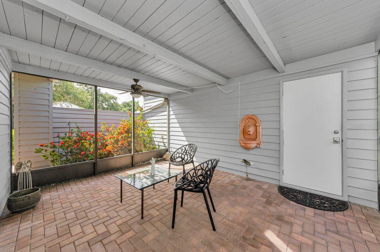 The breezeway with brick pavers and the door into the garage.  What a great private space!
