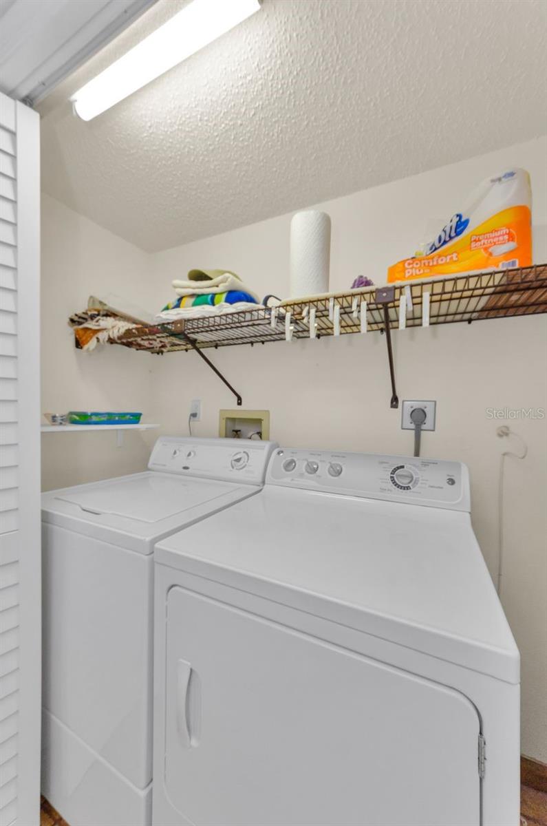 Laundry closet in hallway near bedrooms.