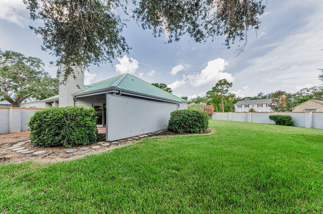 Back yard with surrounding wall. So much privacy!  Room for a pool, there is another private pool in the neighborhood...