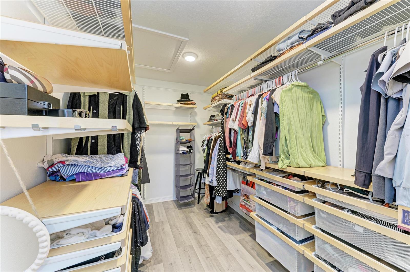 Expansive walk-in closet outfitted with custom built-ins