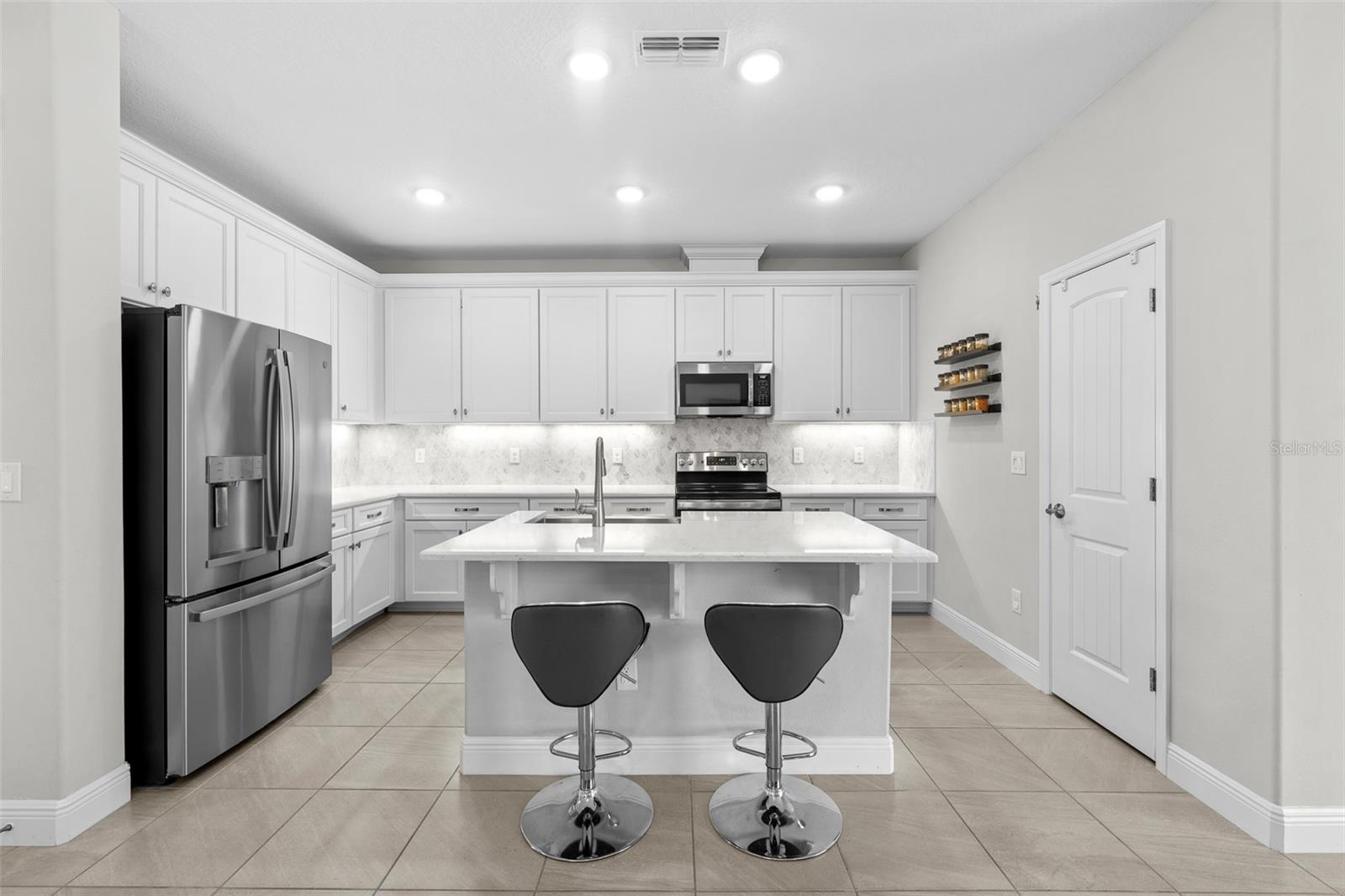 Modern kitchen with quartz countertop and marble backsplash