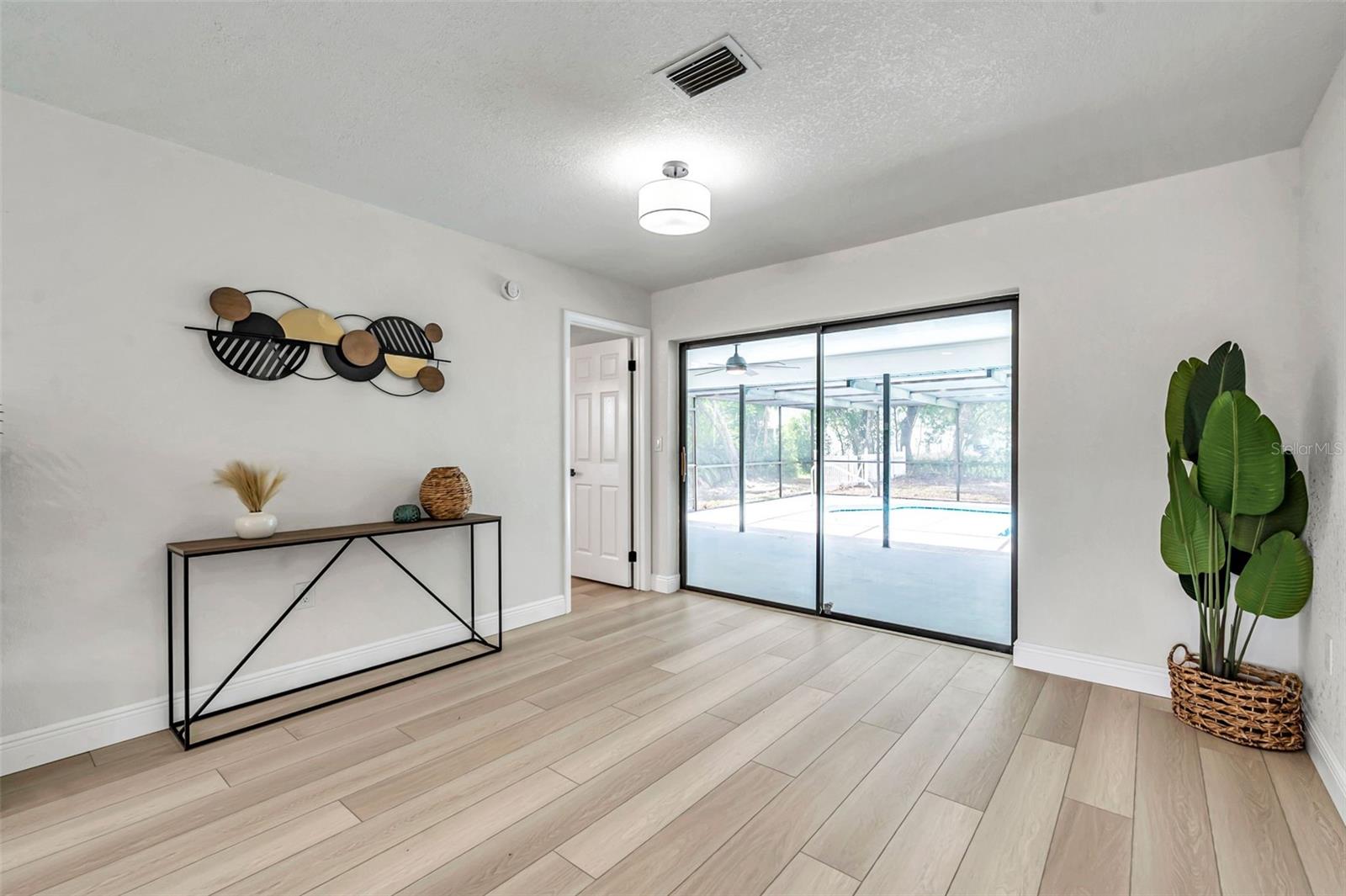 dining room and entrance to primary bedroom and pool