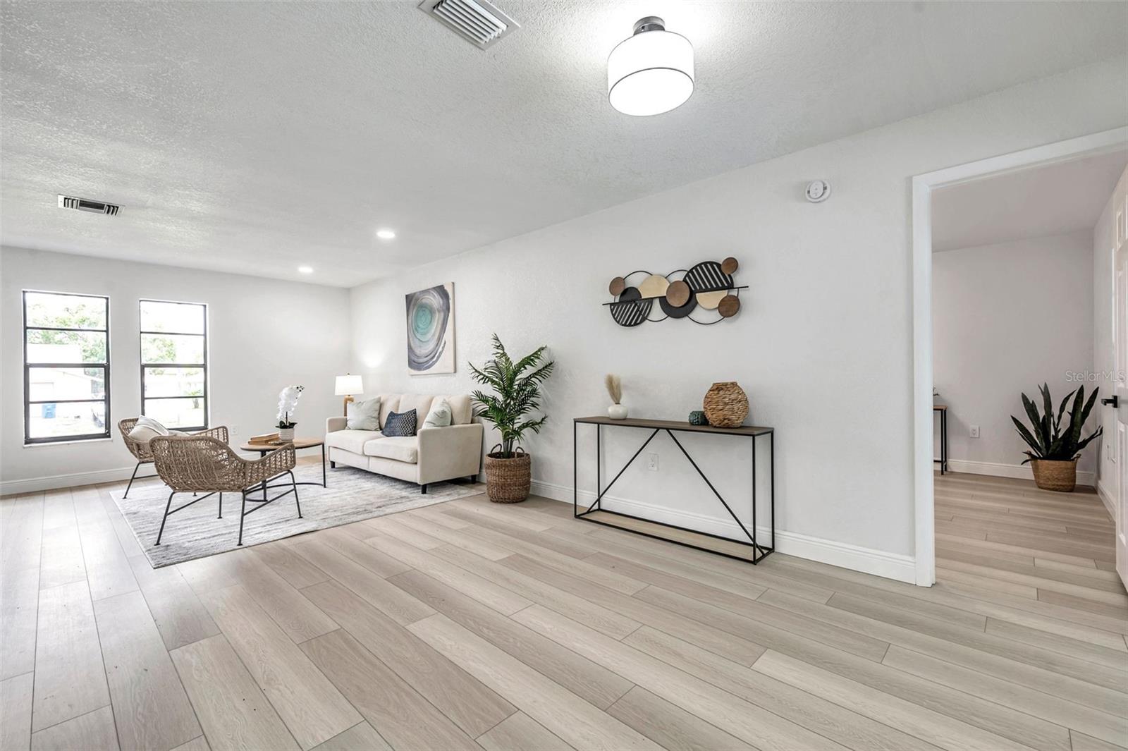 living room, dining room and entry to primary bedroom