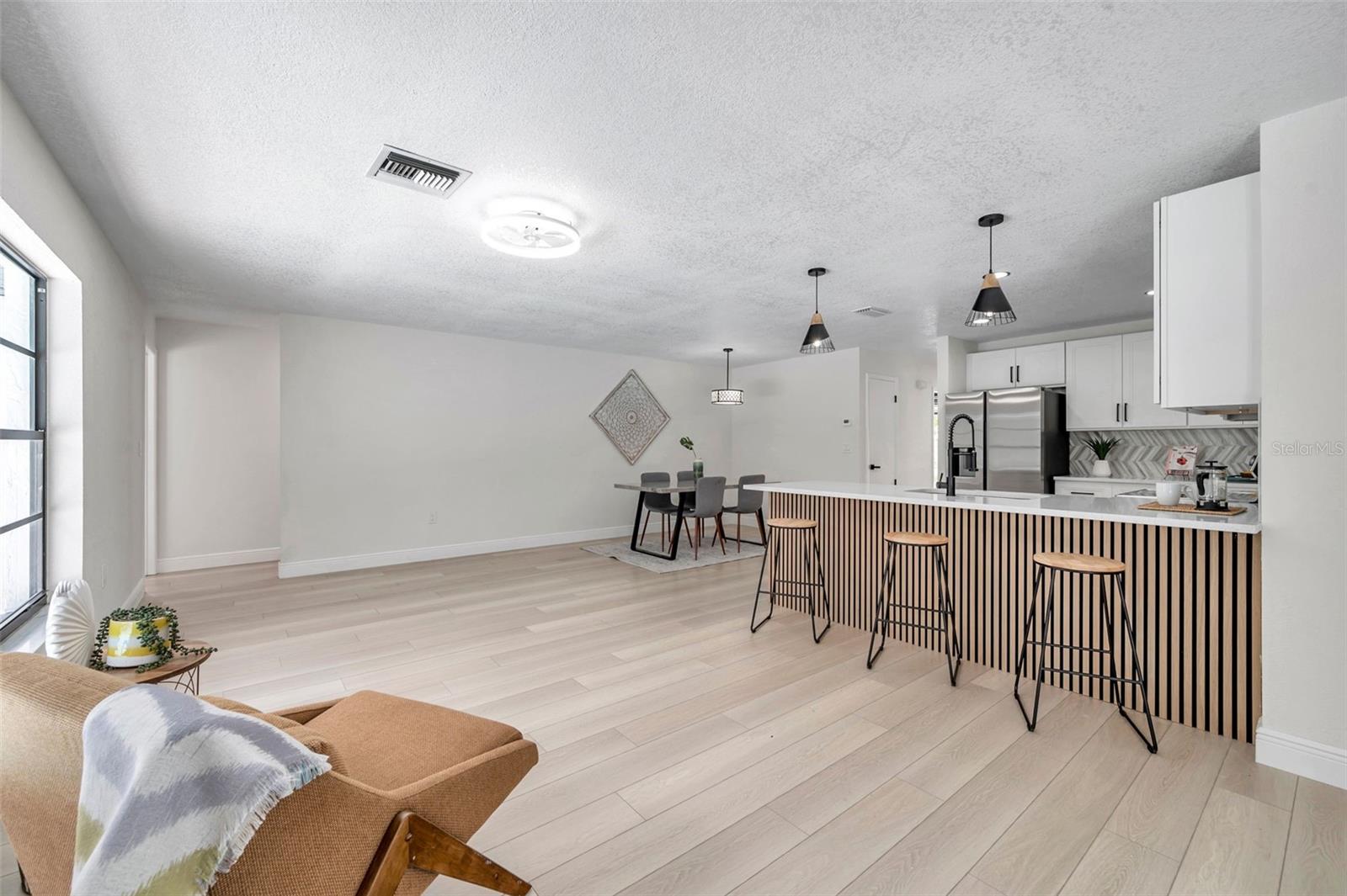 family room, dinette, and hallway to guest bathroom and bedrooms