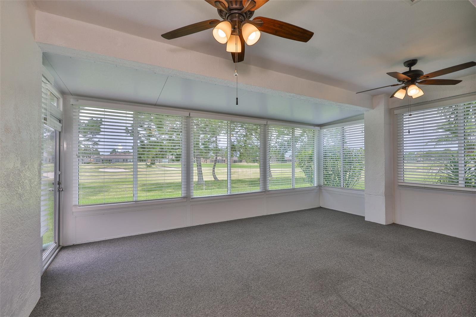 Enclosed patio sitting area, overlooking golf course.