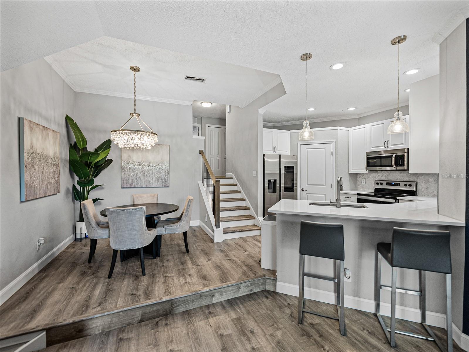 Kitchen with Stone Countertops, Wood Cabinetry + Bar