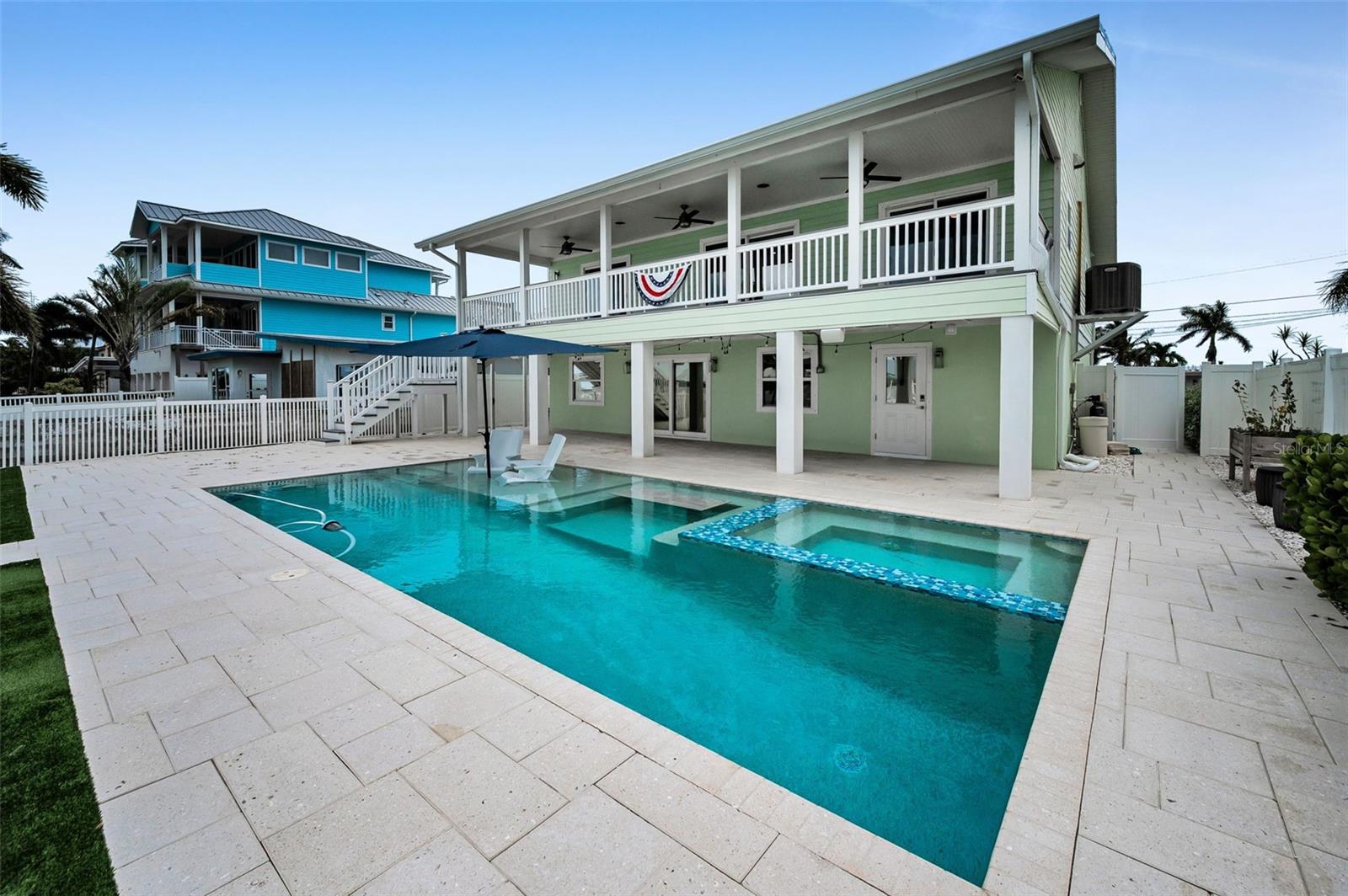 Resort-Style Outdoor Living: The pool, perfectly positioned for sunset swims and alfresco gatherings, anchors the property like a jewel