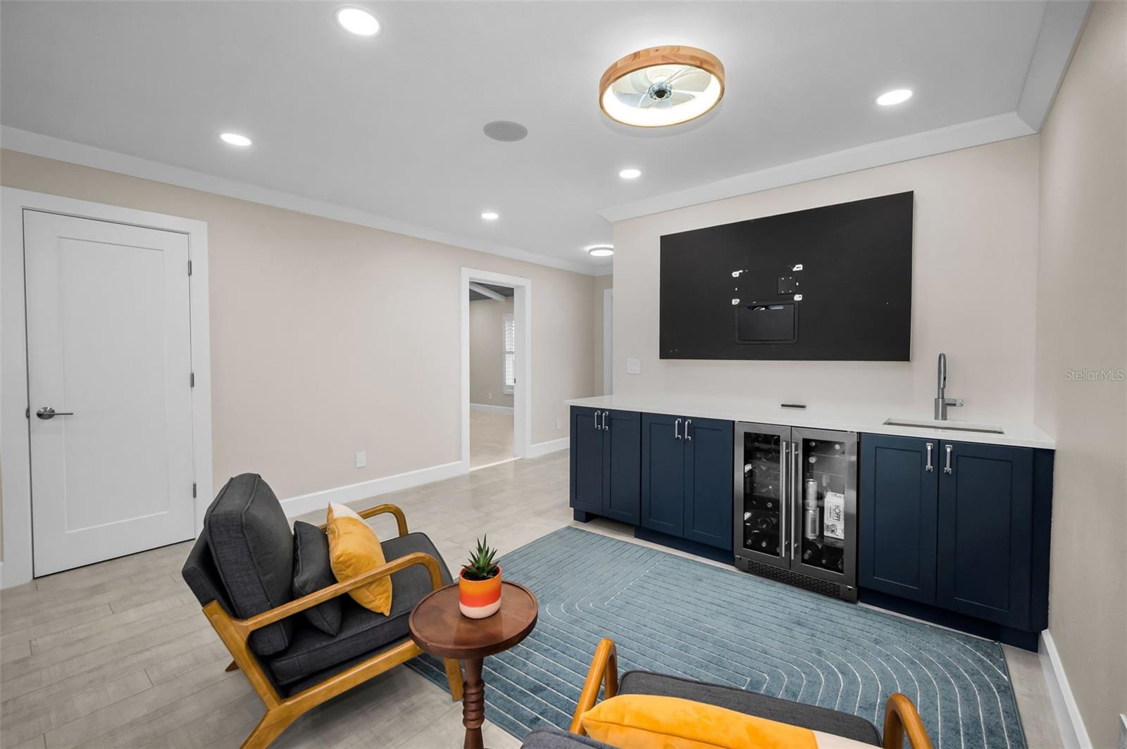 The Sitting area off the Kitchen with the Beverage station / Wet Bar provides a valuable "flex" space with many uses