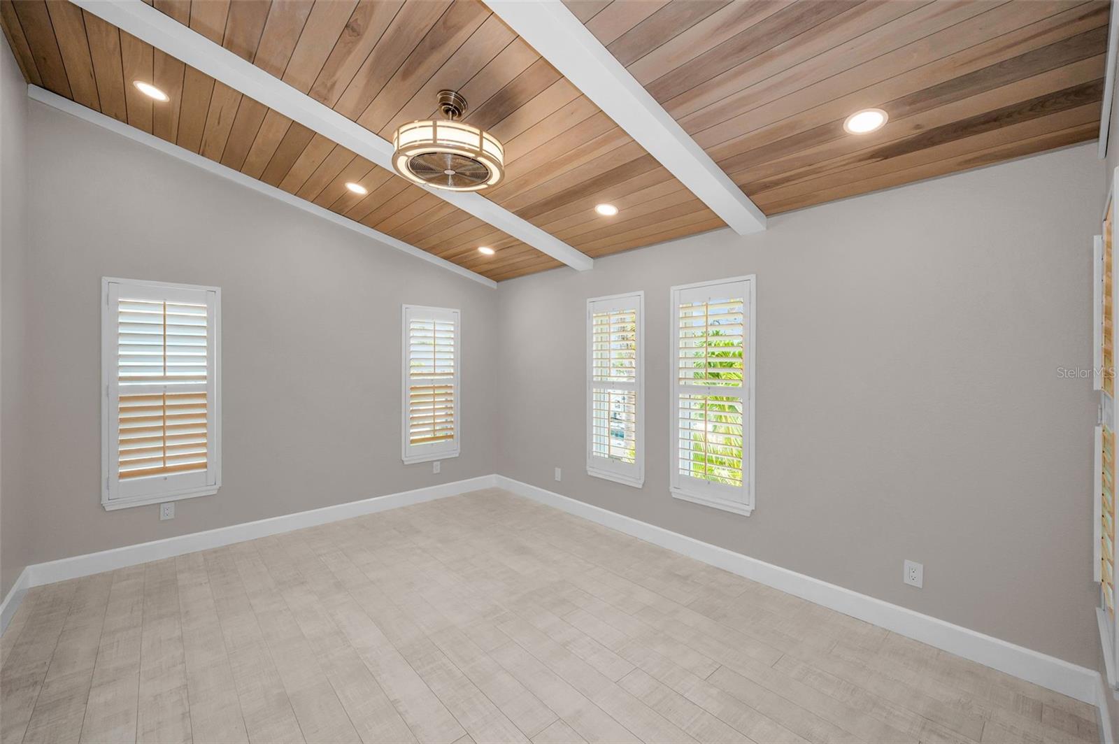 Primary Bedroom with custom beamed, vaulted ceiling.