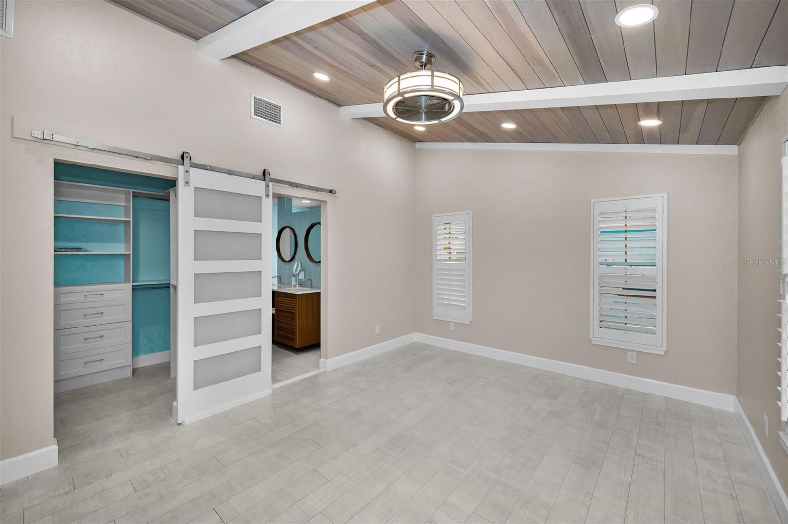 Custom Barn Door in the Primary Bedroom leading to the sumptuous bath!