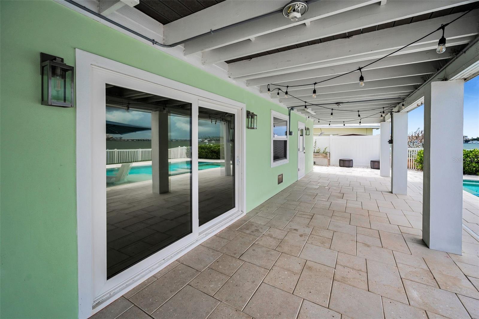 Deep, Full Length Rear Porch leading to the Pool and Waterfront