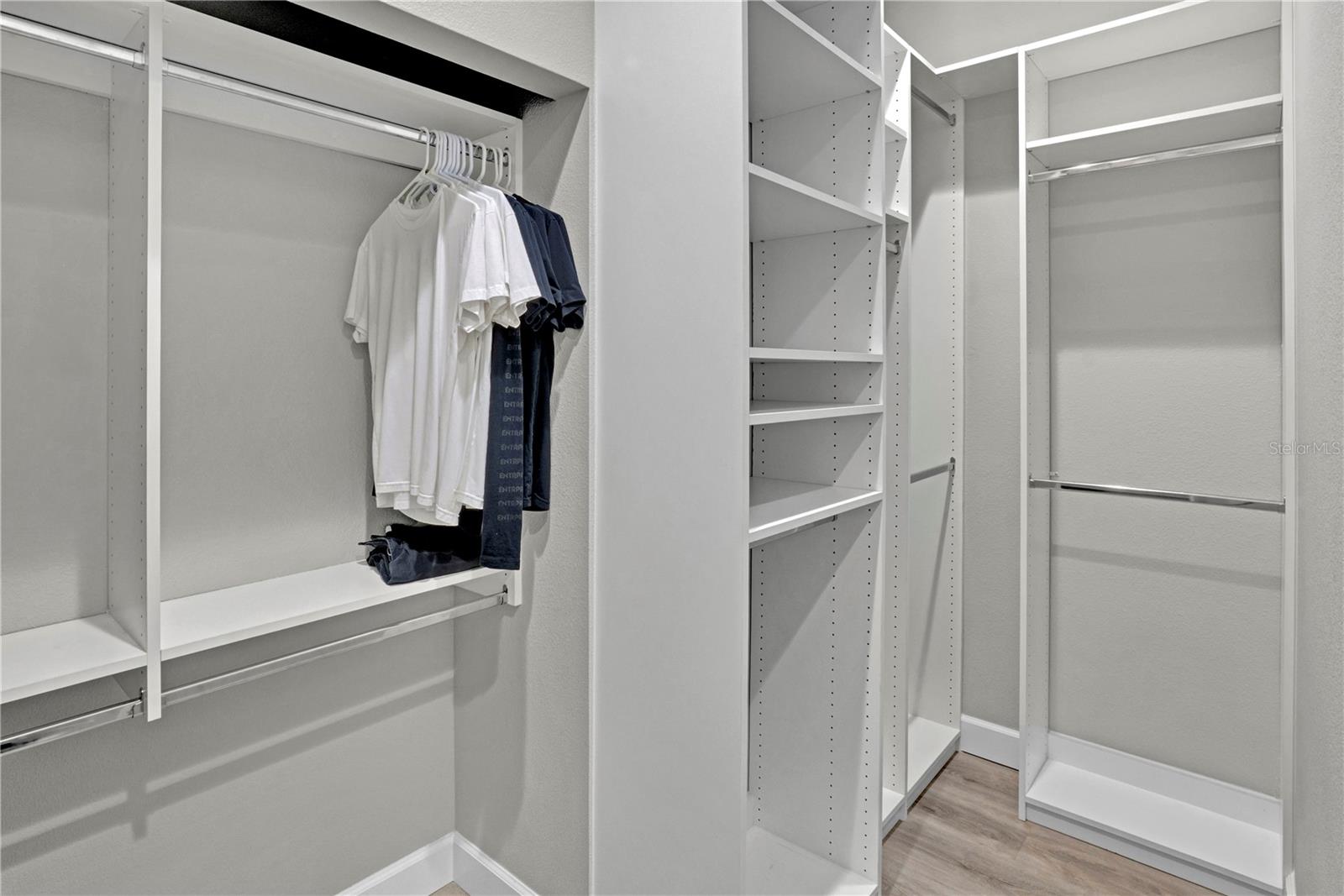 Large primary suite with custom closet organizers.