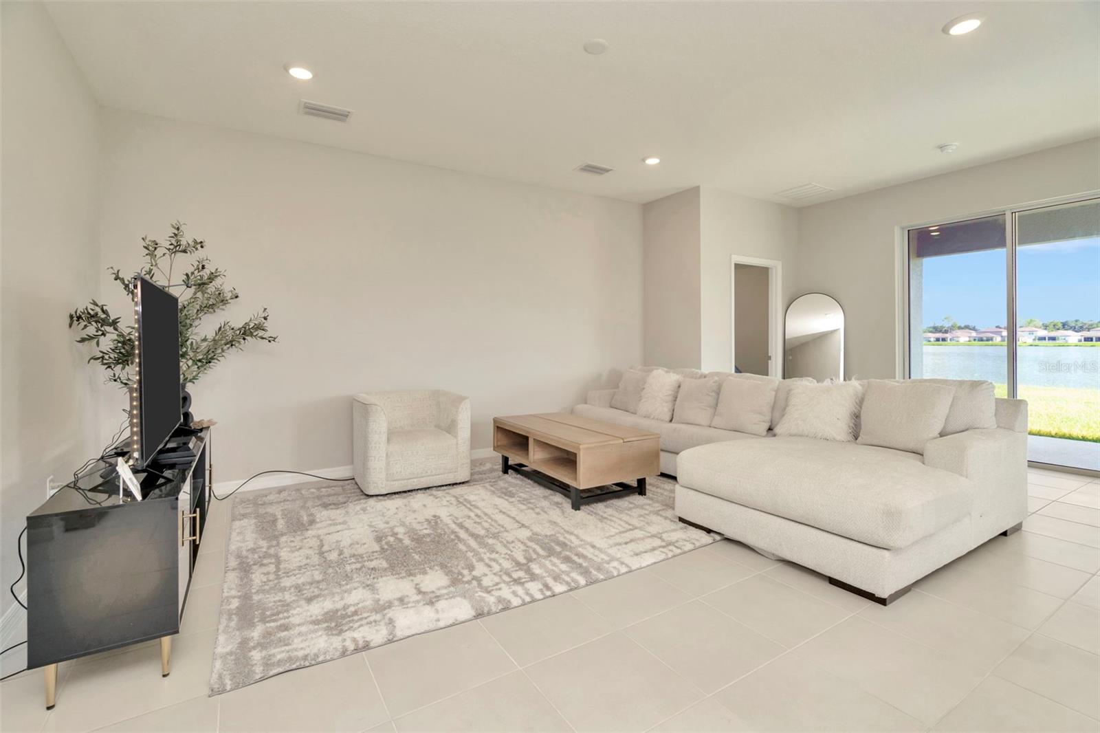 Your spacious great room. Check out the lake views from the sliding glass door.
