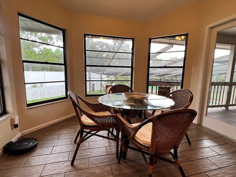 Another dining area surronded by windows.