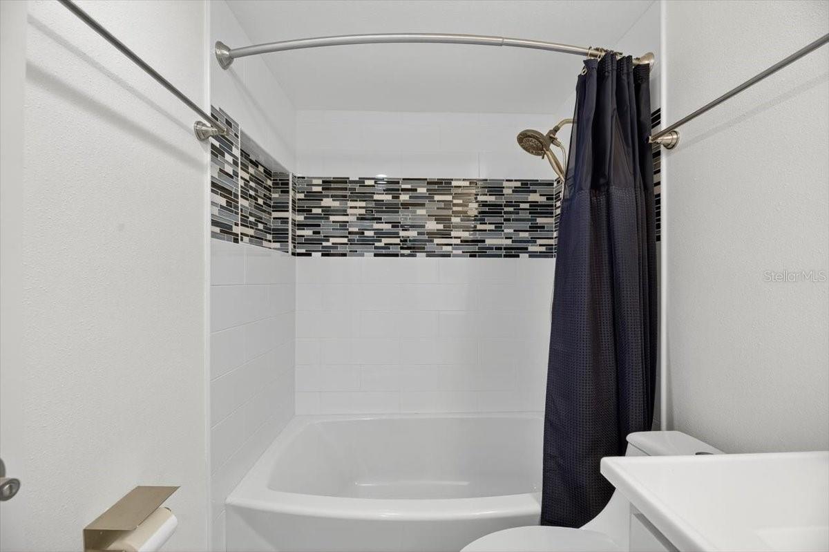 Hall bathroom tub and shower.