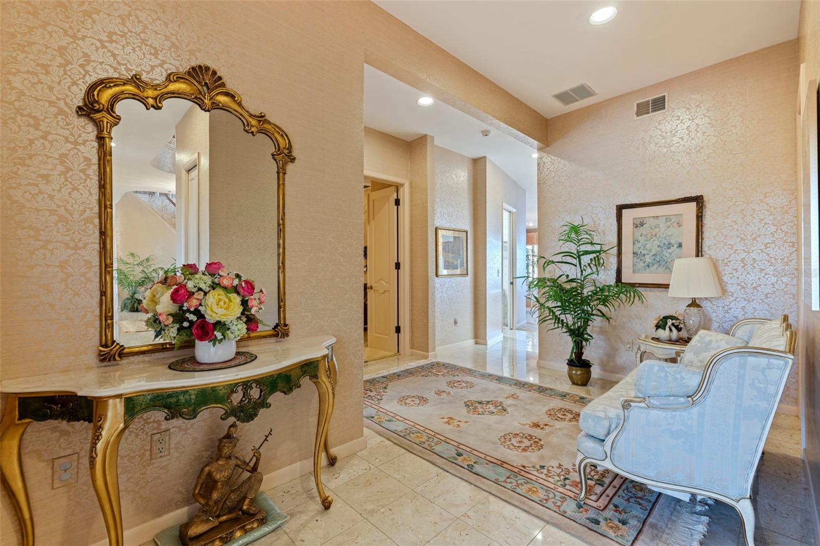 To the left of the front door, this hallway takes you to the downstairs of the in-law suite, the open door is the office, then the laundry room, and then to the formal dining & living rooms.